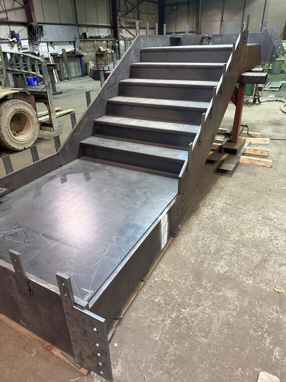 Fabricated steel chassis rail with mounting brackets